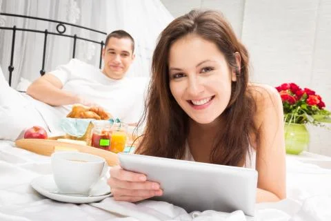 Couple Having Breakfast In Bed Photos