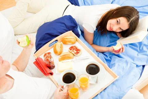 Couple Having Breakfast In Bed 写真素材