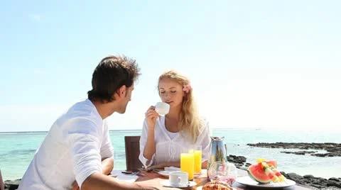 Couple having breakfast by blue lagoon Stock-Footage 14827701