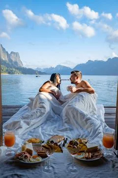 Couple having breakfast in front of floating wooden room visiting Khao Sok Stock Photos