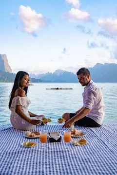 Couple having breakfast in front of floating wooden room visiting Khao Sok Stock Photos