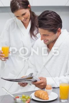 Couple having breakfast in the kitchen Stock Photos