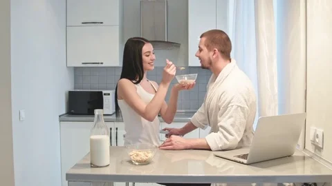 Couple having breakfast together playing each other Stock Footage 75042644