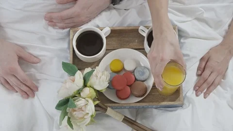 Couple is having delicious breakfast in white bed in the morning Stock Footage 73349304