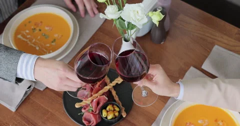 Couple having a dinner, clinking glasses of wine at a restaurant. Stock Footage 319005232