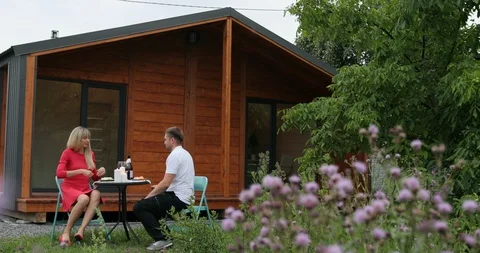 A couple is having dinner outdoors when it starts raining. A couple is having Stock Footage 98246151