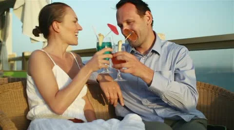 Couple having drinks and relaxing at an outdoor restaurant HD Stock Footage 10888285