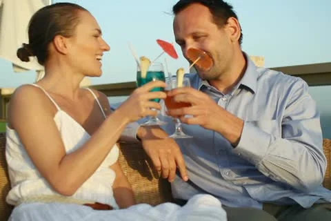 Couple having drinks and relaxing at an outdoor restaurant NTSC Stock Footage 10888288