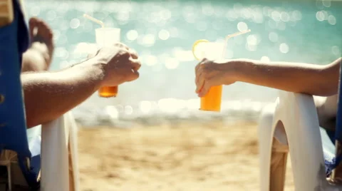 Couple having drinks by the pool on vacation  Stock Footage 1068254