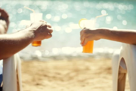 Couple having drinks by the pool on vacation  Stock Footage 1068261