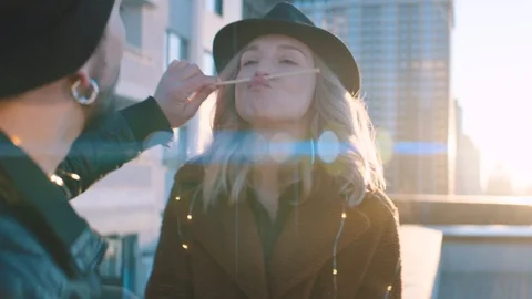 Couple having fun and eating sushi outdoors at sunrise Stock Footage 128525106