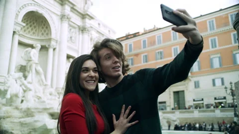 Couple having fun and posing in front of the Trevi Fountain and taking pictures Stock Footage 199463763