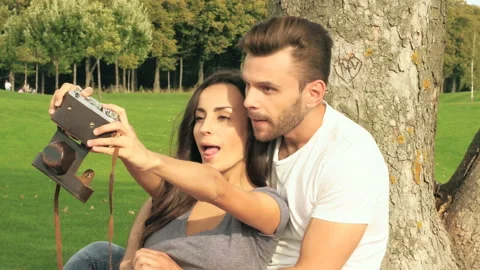 Couple having fun and taking photos (selfies) on the old camera. Stock Footage 97601684