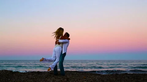 Couple having fun on the beach during the sunset Stock Footage 57108165