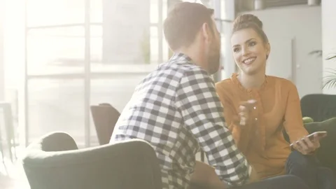 Couple having fun at cafe browsing smartphone together Video stock 70809391