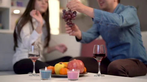 Couple having fun, drinking alcohol and eating fruit. Stock Footage 167863224