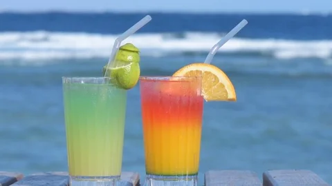 Couple having fun drinking alcoholic cocktail on the background of the sea. Stock Footage 83640314
