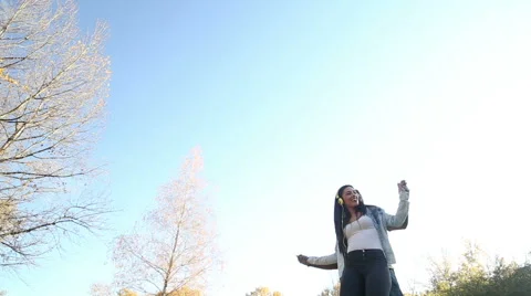 Couple having fun listening to music on headphones and dancing Stock Footage 59554861