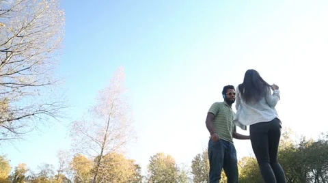 Couple having fun listening to music on headphones and dancing Stock Footage 59554881