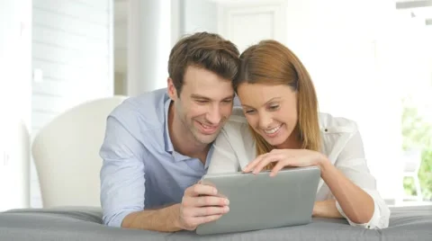 Couple having fun playing with tablet Video stock 58885025