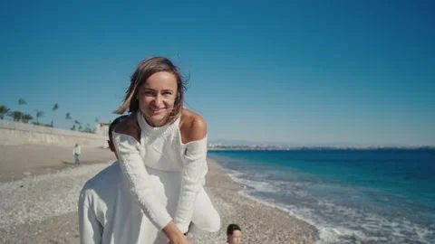 Couple Having Fun Running Along Winter Beach Together Stock Footage 244628141
