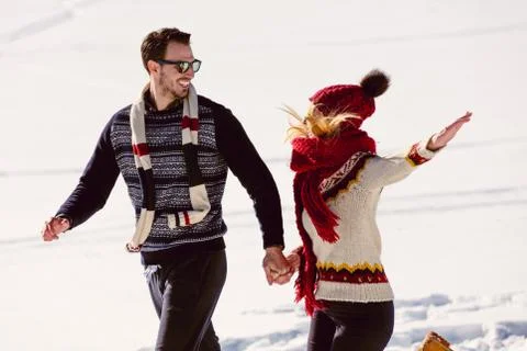 Couple having fun running down slope Foto stock