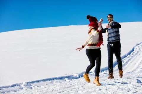 Couple having fun running down slope Stock Photos
