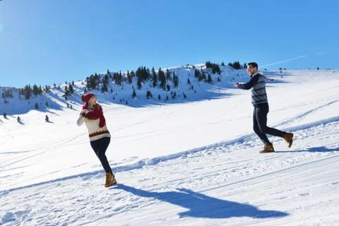 Couple having fun running down slope Foto stock