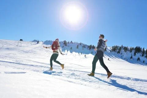 Couple having fun running down slope Stock Photos