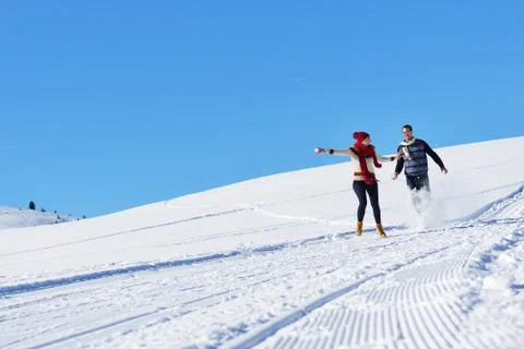 Couple having fun running down slope Stock-Fotos