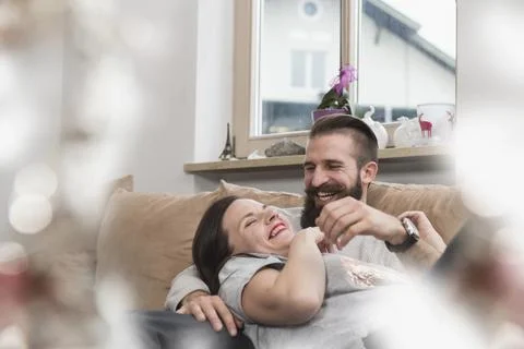 Couple having fun on sofa Stock Photos