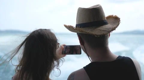 Couple having fun taking selfie video using smart phone on cruise ship Stock Photos