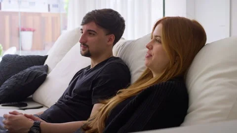 Couple having fun together, talking and watching television. Valentine's Day Stock Footage 247660734