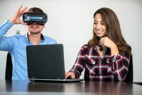 Couple having fun trying VR headset at startup meeting Stock Photos