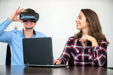 Couple having fun trying VR headset at startup meeting Stock Photos