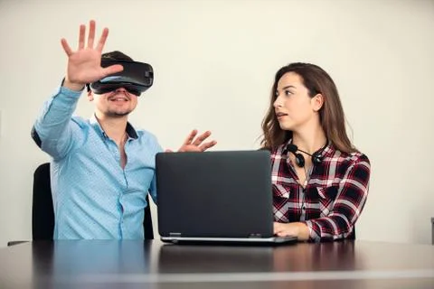 Couple having fun trying VR headset at startup meeting Stock Photos