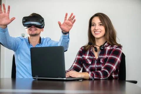 Couple having fun trying VR headset at startup meeting Stock Photos