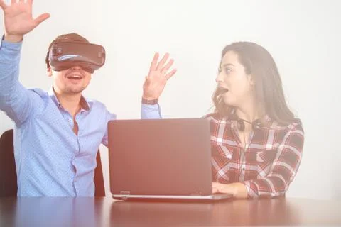 Couple having fun trying VR headset at startup meeting Stock Photos