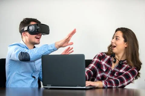 Couple having fun trying VR headset at startup meeting Stock Photos