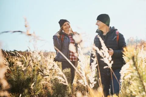 Couple having fun while vacation trip. Hikers with backpacks on way to moun.. Stock Photos