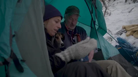 Couple having hot beverage during winter camping Stock Footage 331658690