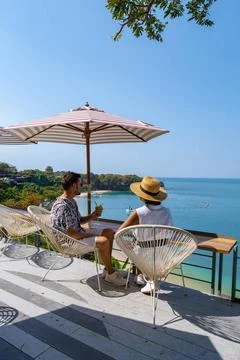 Couple having lunch at an restaurant looking out over the ocean of Pattaya... Fotos Stock