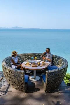 Couple having lunch at an restaurant looking out over the ocean of Pattaya... Fotos Stock