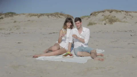 Couple having picnic on a beach Stock Footage 61755341