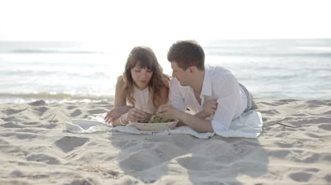 Couple having picnic on a beach Stock Footage 61755406