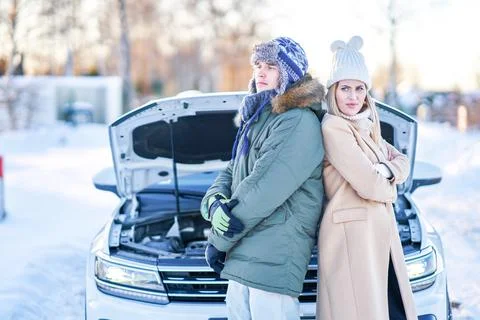 Couple having problem with the car during winter trip Stock Photos