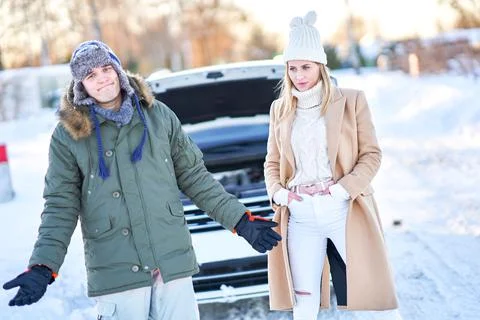 Couple having problem with the car during winter trip Stock Photos