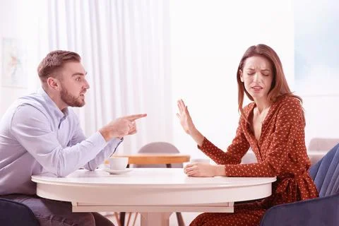 Couple having quarrel in cafe. Cheating and breakup Stock Photos