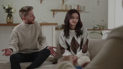 Couple having relationship problems. Man and woman talking to psychologist Stock Footage 233193498