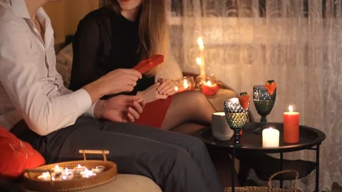 Couple having a romantic dinner decorated with candles at home. Valentine's day. Video stock 169048581
